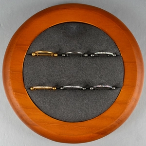 Detailed collection of G23 titanium nipple shields with opal and zircon inlays on display