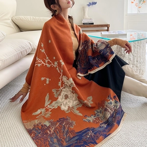 Detailed view of orange cashmere-like scarf with Chinese floral patterns and fringed edges