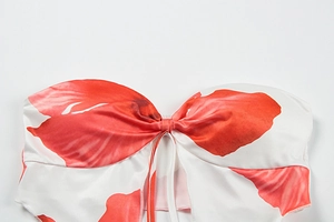 Detail of red floral print tube top with drawstring bow and thin shoulder straps