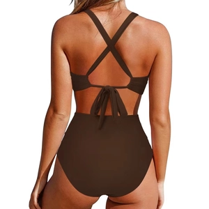 Detail of dark brown high-waisted swimsuit with cross-back straps and decorative bow tie