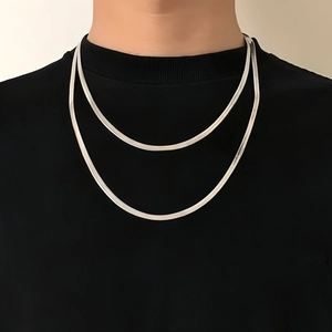 Close-up of double layered silver snake bone chain necklace on a model's neck