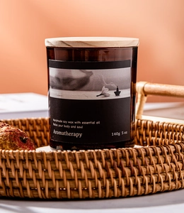 5 oz soy wax aromatherapy candle in amber glass jar with wooden lid inside a woven basket