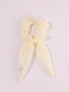 Detail of light beige LED scrunchie with long ribbons in soft chiffon fabric