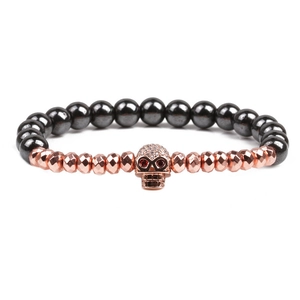 Natural stone beaded bracelet featuring hematite and rose gold beads with a skull charm