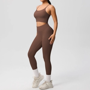 Close-up of brown two-piece yoga set featuring strappy sports bra and high-waisted leggings