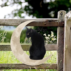 Decorative metal wall art featuring a black cat on a crescent moon for outdoor fences