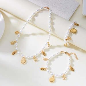 Bohemian beach jewelry set with pearls, golden starfish and seashell pendants