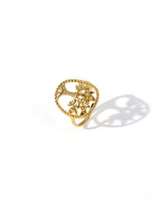 Macro view of 18k gold plated stainless steel tree of life ring with rope edge detail