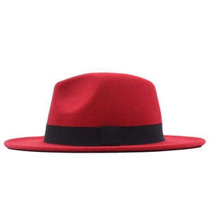 Close-up of red wool felt fedora hat featuring a stylish black decorative ribbon band