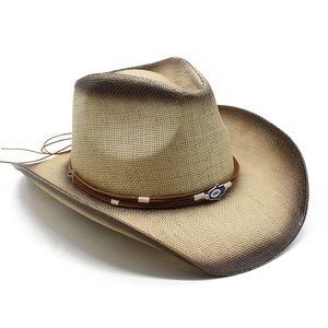Detail of western straw cowboy hat with gradient edges and evil eye emblem decoration