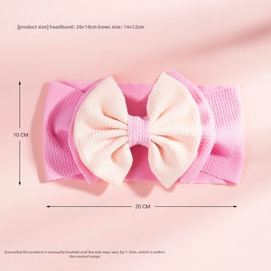 Detail showing 20x10cm waffle knit headband size with a large 14x12cm handmade bow