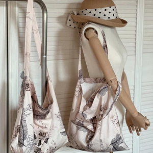 Close-up of linen tote bags with tropical leaf prints and long shoulder straps