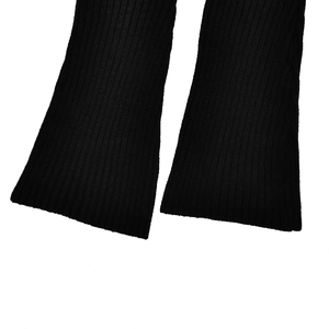 Macro view of black ribbed knit fabric showing detailed vertical texture and elastic hem