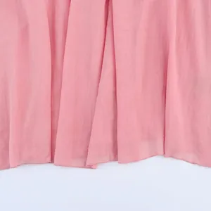 Pink chiffon midi dress with elegant pleated fabric and soft drape on white background