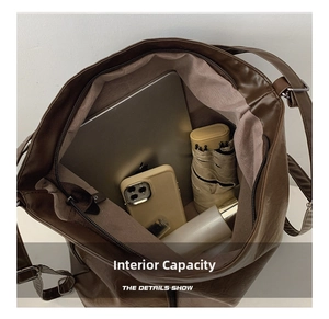 Spacious interior of large brown PU shoulder bag showing room for laptop and daily items