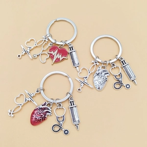 Detail of medical keychains with stethoscope, syringe, and red enamel heart charms