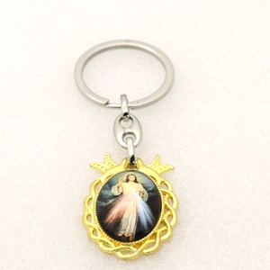 Close-up of Divine Mercy Jesus icon in an ornate gold-plated metal keychain pendant
