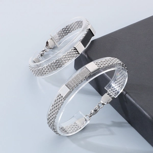 Detail of woven stainless steel snake chain bracelet with black grid texture inlay