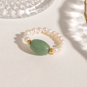 Handcrafted pearl ring with a large oval green natural stone and gold bead accents