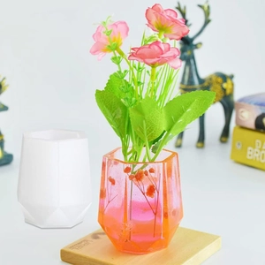 Detailed comparison of hexagonal silicone mold and finished resin flower vase with dried flowers