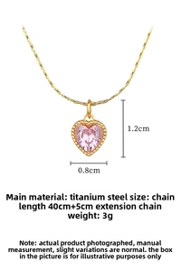 Macro detail of gold-plated heart necklace featuring a pink stone with size parameters