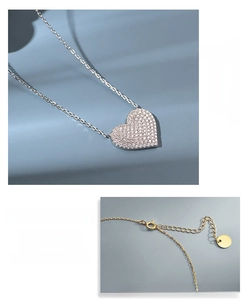 Detail of adjustable silver extender chain and lobster clasp on heart pendant necklace