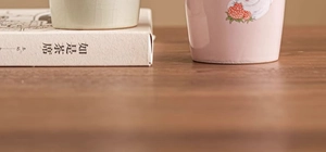 Detailed macro view of pink Ru kiln ceramic cup with strawberry rabbit pattern