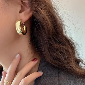 Minimalist chunky golden C-shaped hoop earrings with polished mirror finish for women