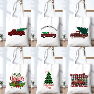 White canvas Christmas tote bags featuring red and green holiday truck and tree prints