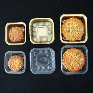 Macro detail of 7.5cm clear and gold PET plastic mooncake trays with square rounded edges