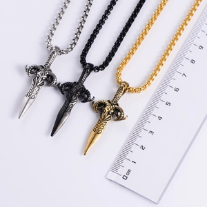 Close-up of sword pendant necklaces in gold and black with ruler showing 5cm length