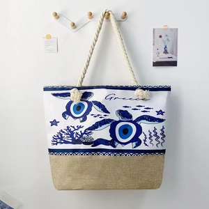 Detail of canvas beach bag with turtle evil eye print, jute bottom and rope handles