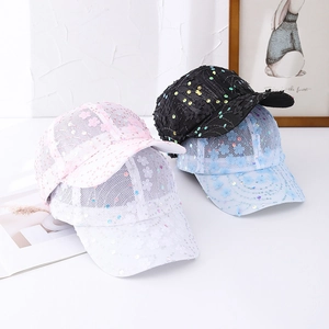 Detail of mesh baseball caps featuring colorful sequins and delicate floral decorations