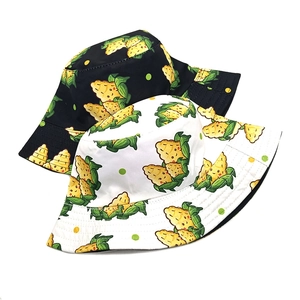 Reversible bucket hat with cartoon corn print in black and white for sun protection