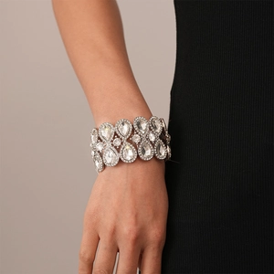 Close-up of luxury silver-tone elastic bracelet with clear teardrop crystals on wrist