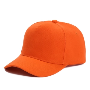 Detailed macro shot showing the orange twill fabric texture and curved brim of the baseball cap