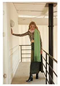 Detail of wool blend gradient scarf with tassels worn by model for winter style