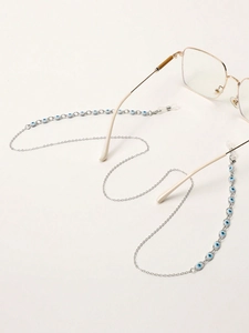 Detailed view of silver chain glasses strap with blue evil eye beads on white background