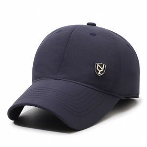 Winter thermal baseball cap in dark blue with fleece lining and metal shield logo detail
