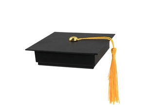 Close-up of black graduation cap gift box with yellow tassel and gold buckle