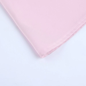 Detail shot of the pink smooth fabric featuring neat curled edge sewing craftsmanship