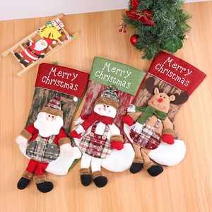 Three festive Christmas stockings with 3D Santa, snowman, and reindeer on wood background