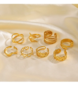Detailed view of 8-piece 18K gold-plated ring set on elegant champagne silk fabric