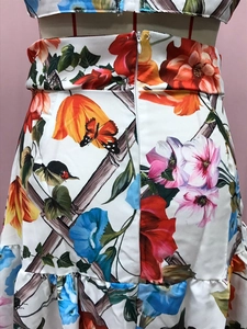Detail of floral printed maxi dress with orange flowers, insects and a wide waistband