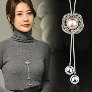 Detail of silver snake chain necklace with crystal flower pendant and champagne pearl