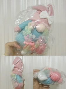 Detail of Easter bunny gnome with pink rabbit ears and colorful braided hair in packaging