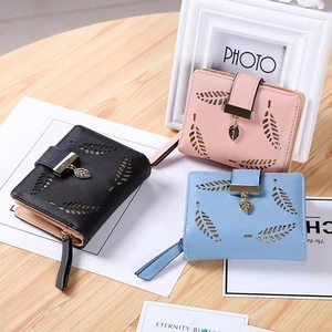 Three long PU leather women's wallets with leaf cutout design and metal pendant in pastels