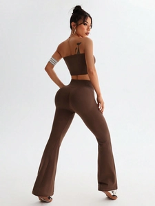 Rear view of brown two-piece yoga set showing high-waist flared pants and crop top