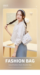 Detail of floral embroidery on white leather shoulder bag with transparent PVC base