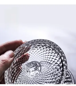 Close-up of clear crystal glass jewelry jar featuring refined embossed diamond patterns